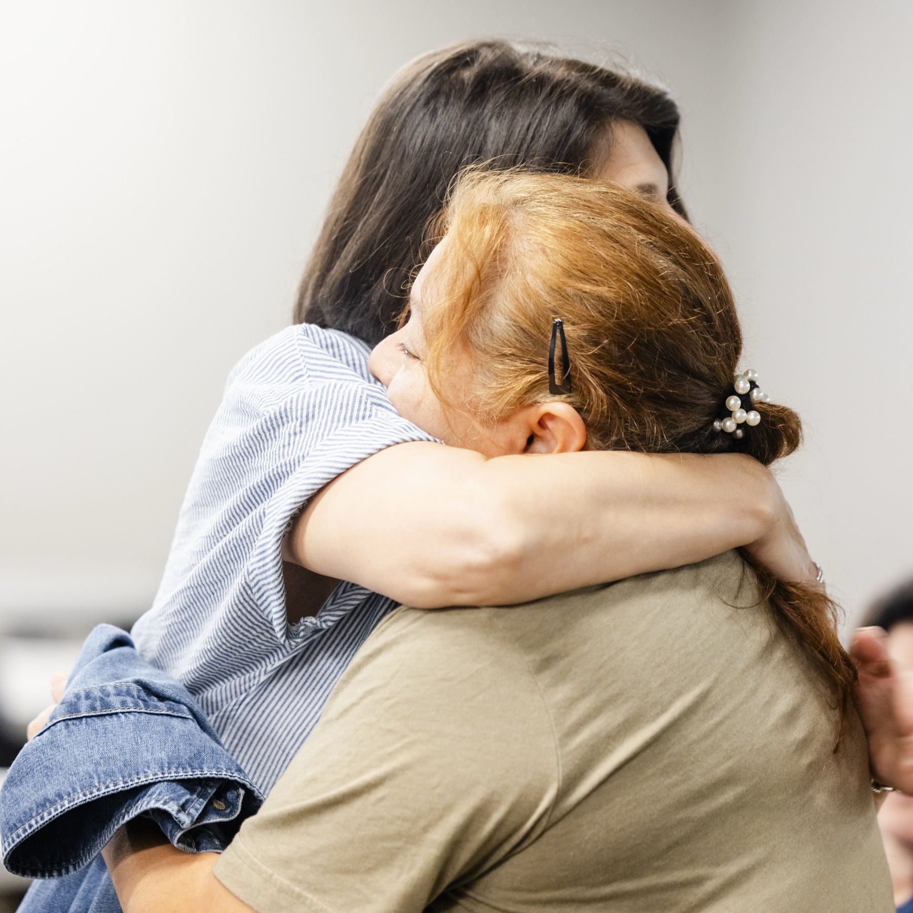Two women hugging during an Adult Singles gathering